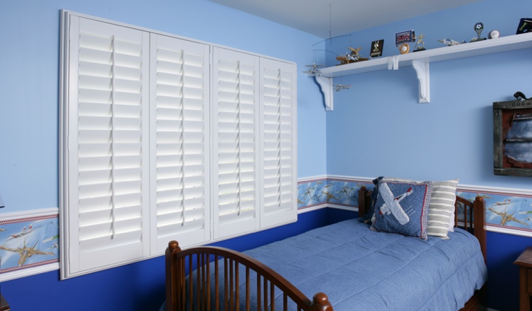 Blue kids bedroom with white plantation shutters in Cincinnati 